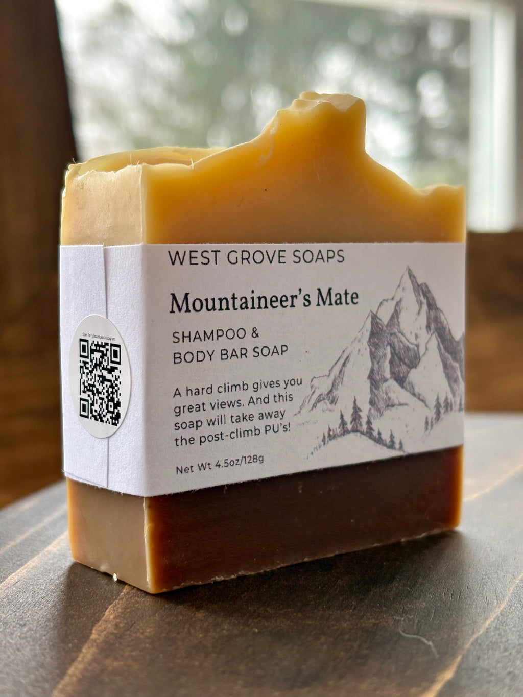 West Grove Soaps Mountaineer's Mate Shampoo & Body Bar Soap on a wooden surface with a blurred natural background