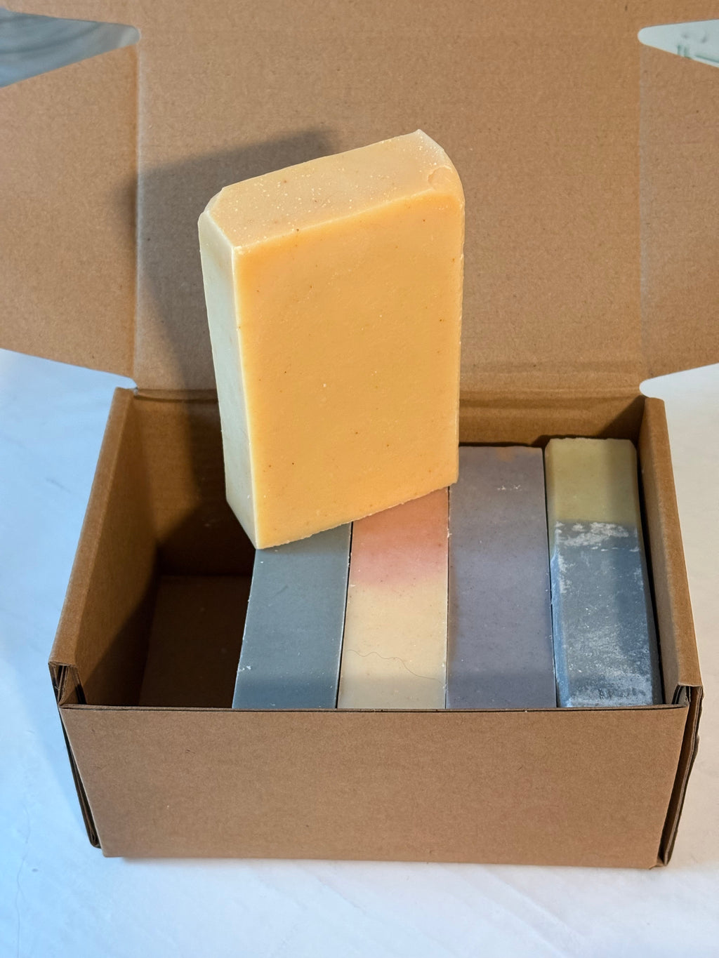Five bars of soap in a cardboard box
